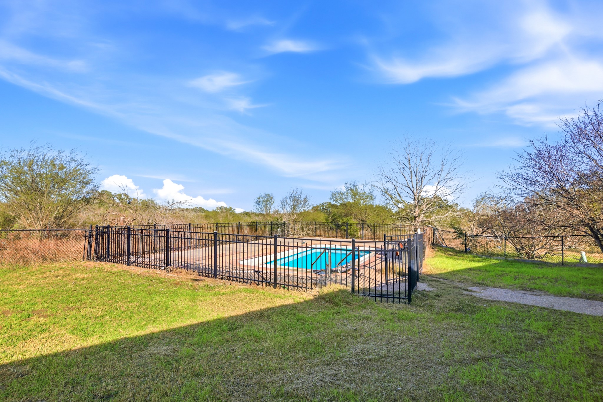 6347 Old Goliad Road Goliad, TX 77963 - Photo 30 of 42 a view of a swimming pool with a garden and trees