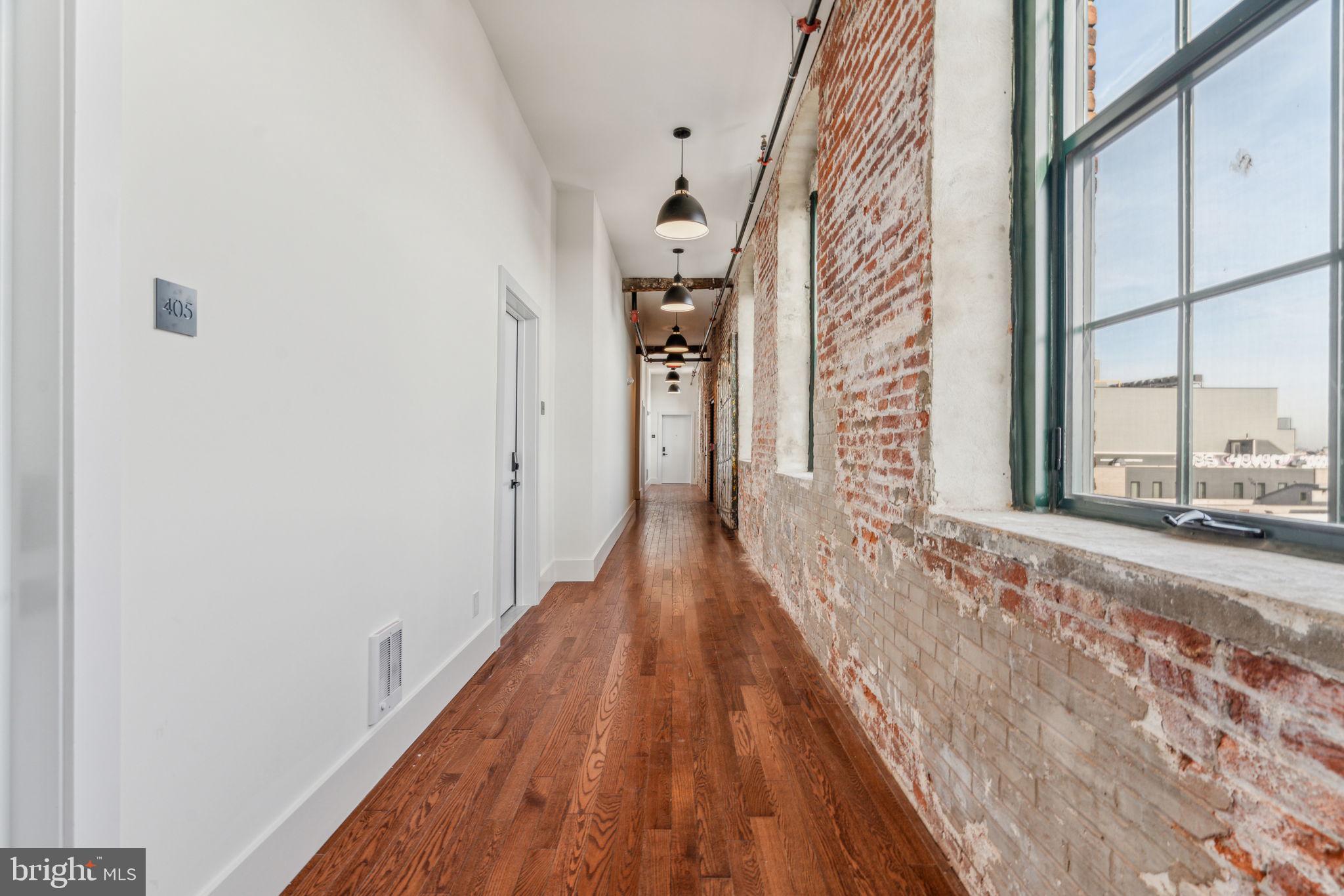 1801 North Howard Street, Unit 1 Philadelphia, PA 19122 - Photo 24 of 29 a view of a hallway with wooden floor and a bathroom