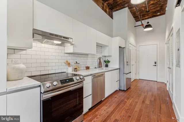 a kitchen with a stove and white cabinets