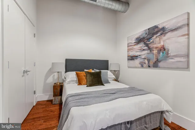 a bedroom with a bed and wall painting