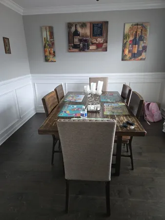 a dining room with furniture and wooden floor