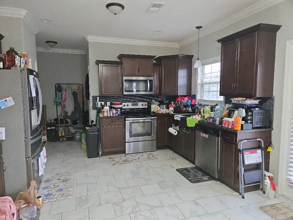a kitchen with refrigerator and cabinets