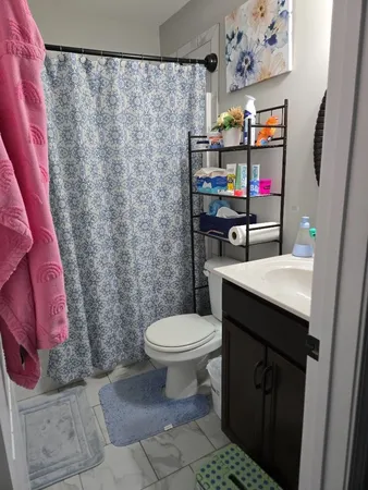 a bathroom with a sink toilet and shower