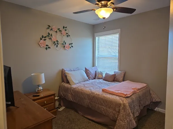 a bedroom with a bed and a chandelier