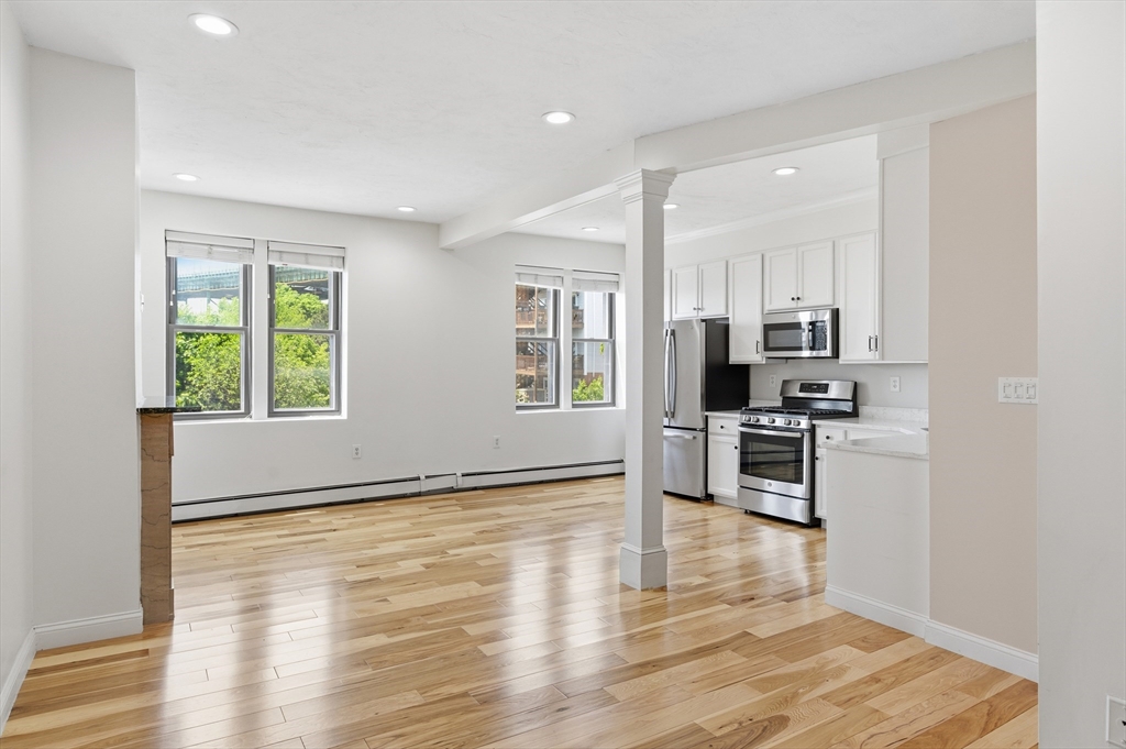 54 Beacon Street, Unit 2 Chelsea, MA 02150 - Photo 11 of 26 a view of kitchen with sink microwave refrigerator and cabinets