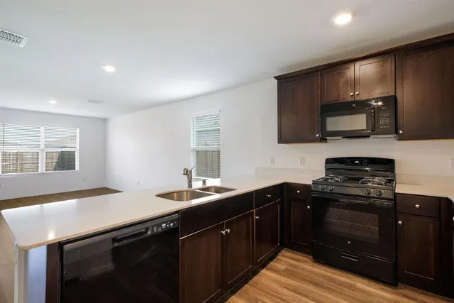 a kitchen with a sink stove and microwave