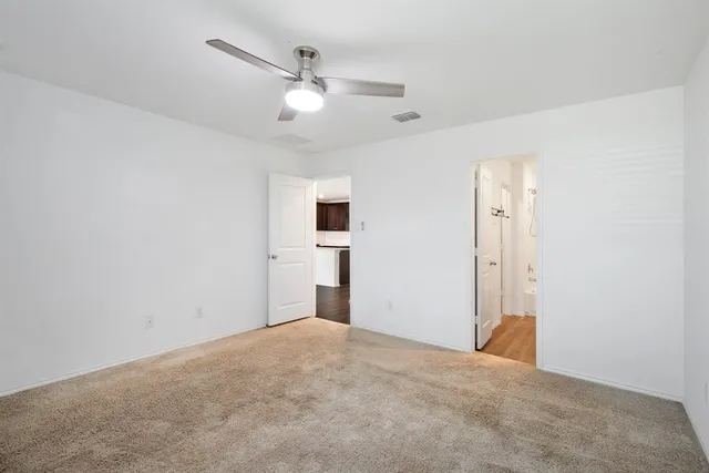 a view of a livingroom with a ceiling fan and window