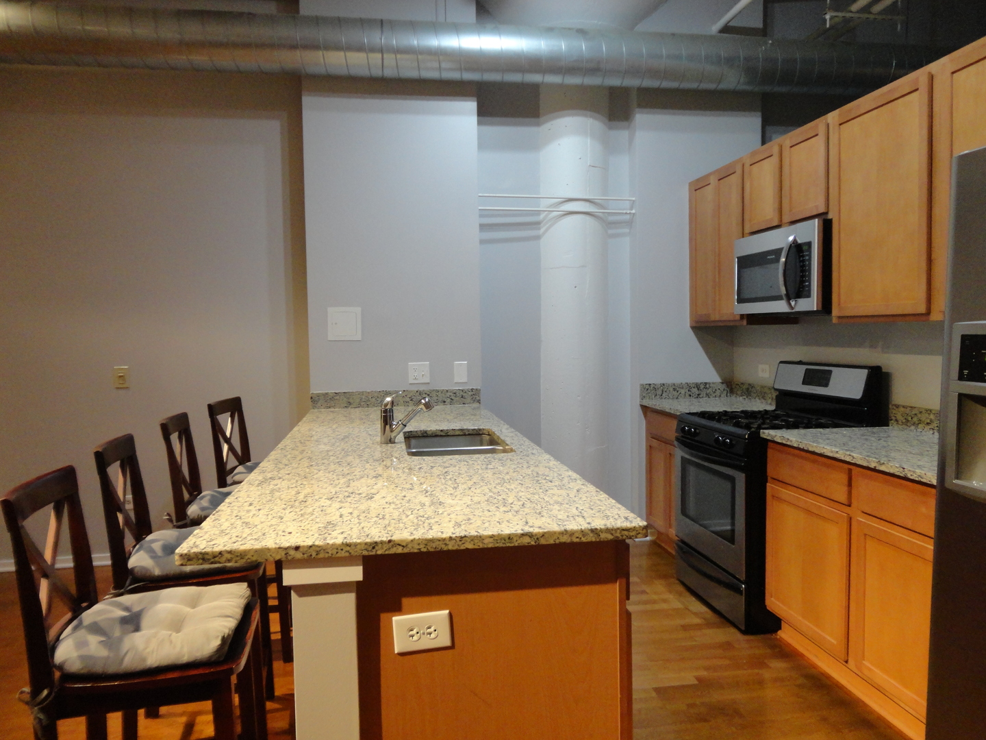 2323 West Pershing Road, Unit 136 Chicago, IL 60609 - Photo 12 of 20 a kitchen with a stove and a refrigerator