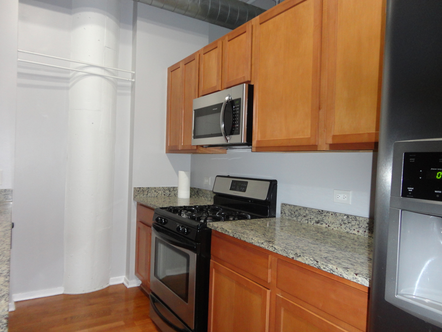2323 West Pershing Road, Unit 136 Chicago, IL 60609 - Photo 13 of 20 a kitchen with granite countertop cabinets stainless steel appliances and a counter space