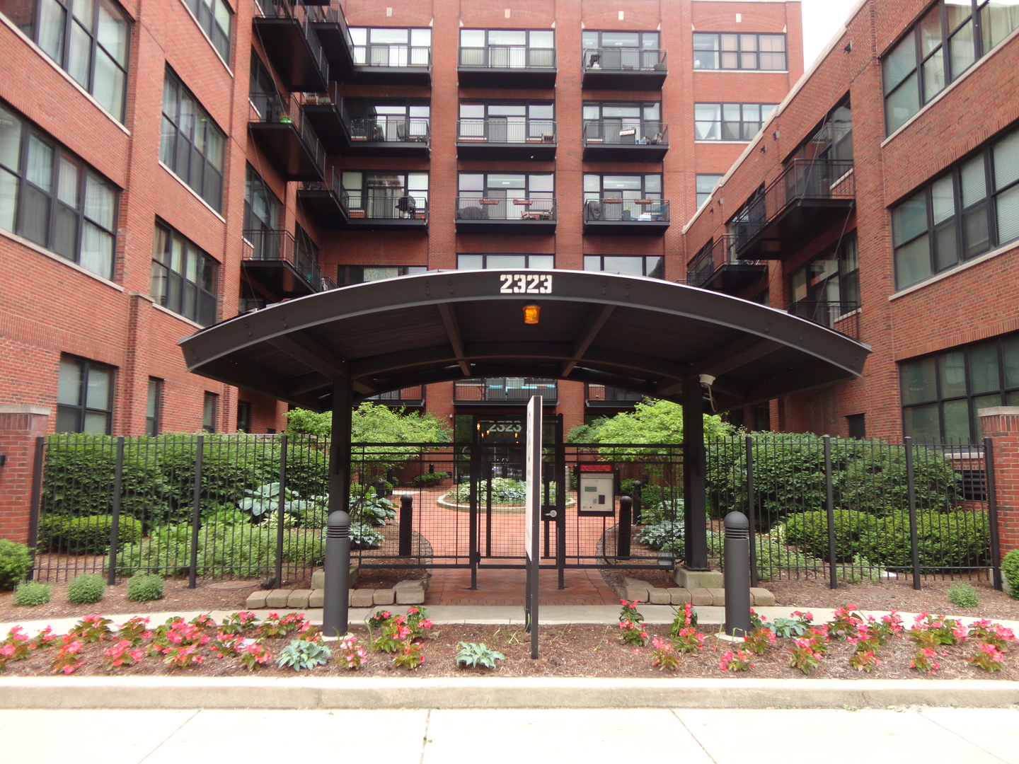 2323 West Pershing Road, Unit 136 Chicago, IL 60609 - Photo 3 of 20 a view of a building with a porch and furniture