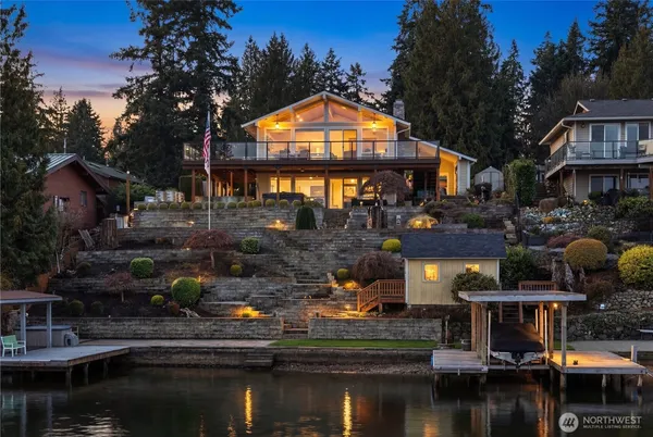 a view of house with lake view and a car parked