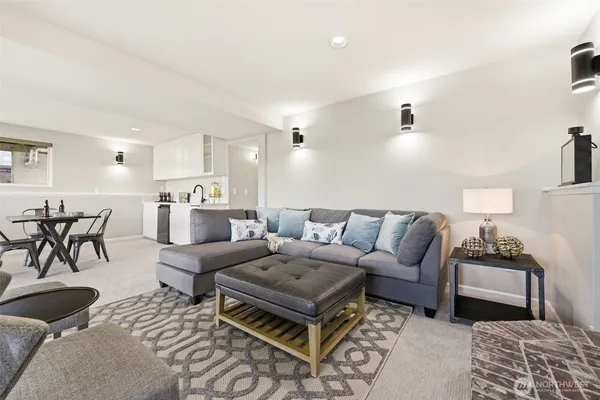 a living room with furniture and view of kitchen