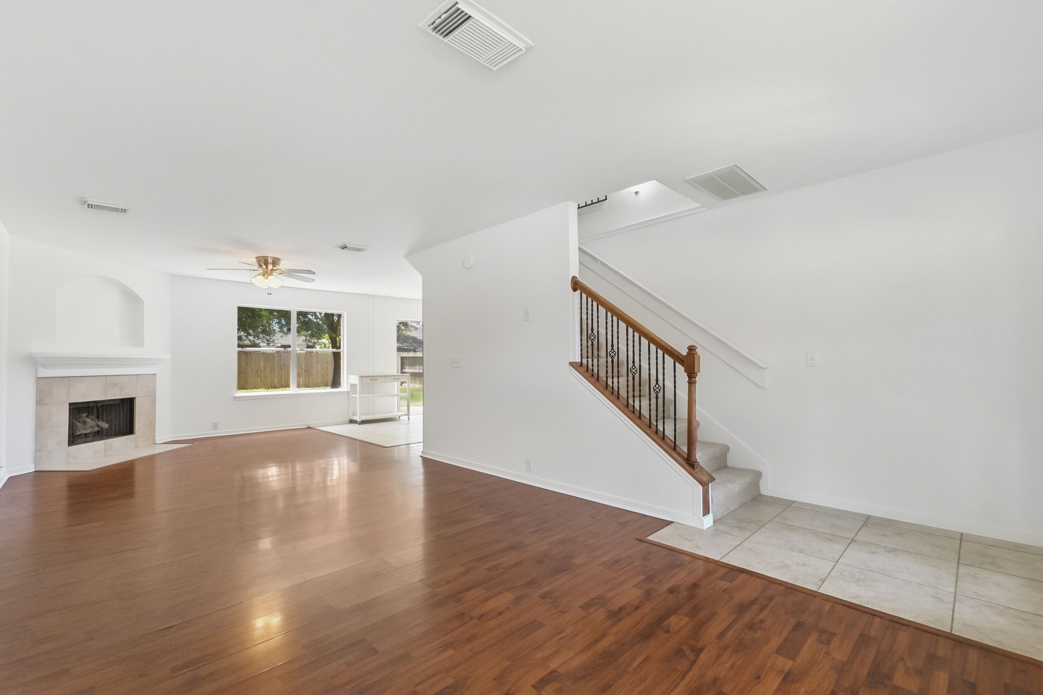 11907 Ezekiel Road Tomball, TX 77375 - Photo 5 of 39 a view of an empty room with wooden floor and a fireplace