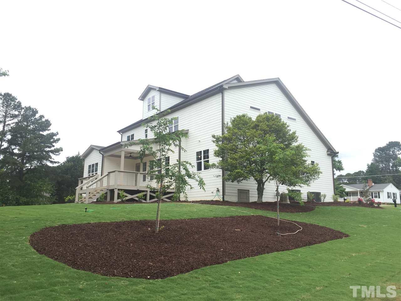 118 Reynolds Road Raleigh, NC 27609 - Photo 14 of 19 a view of a big house with a big yard and palm trees