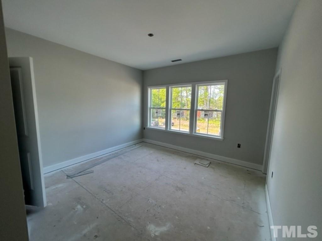 115 Cackling Way Zebulon, NC 27597 - Photo 20 of 44 a view of an empty room with a window