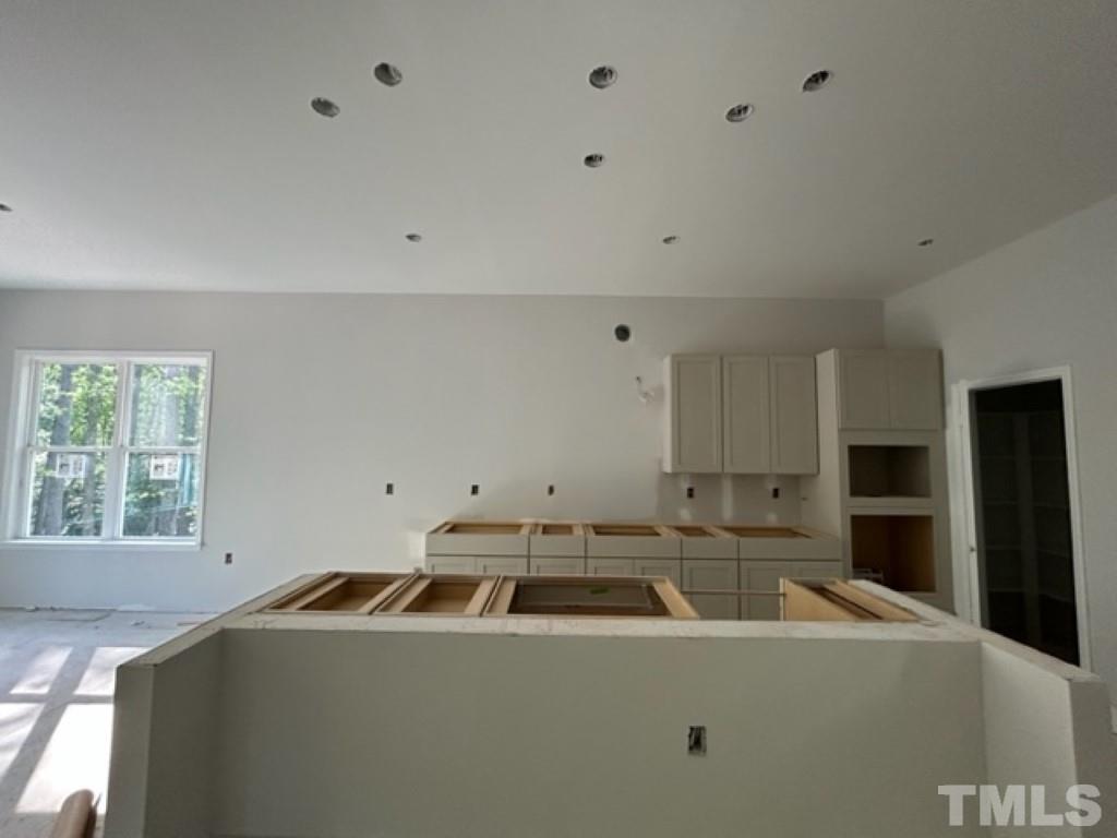 115 Cackling Way Zebulon, NC 27597 - Photo 4 of 44 a room with furniture a large window and stainless steel appliances