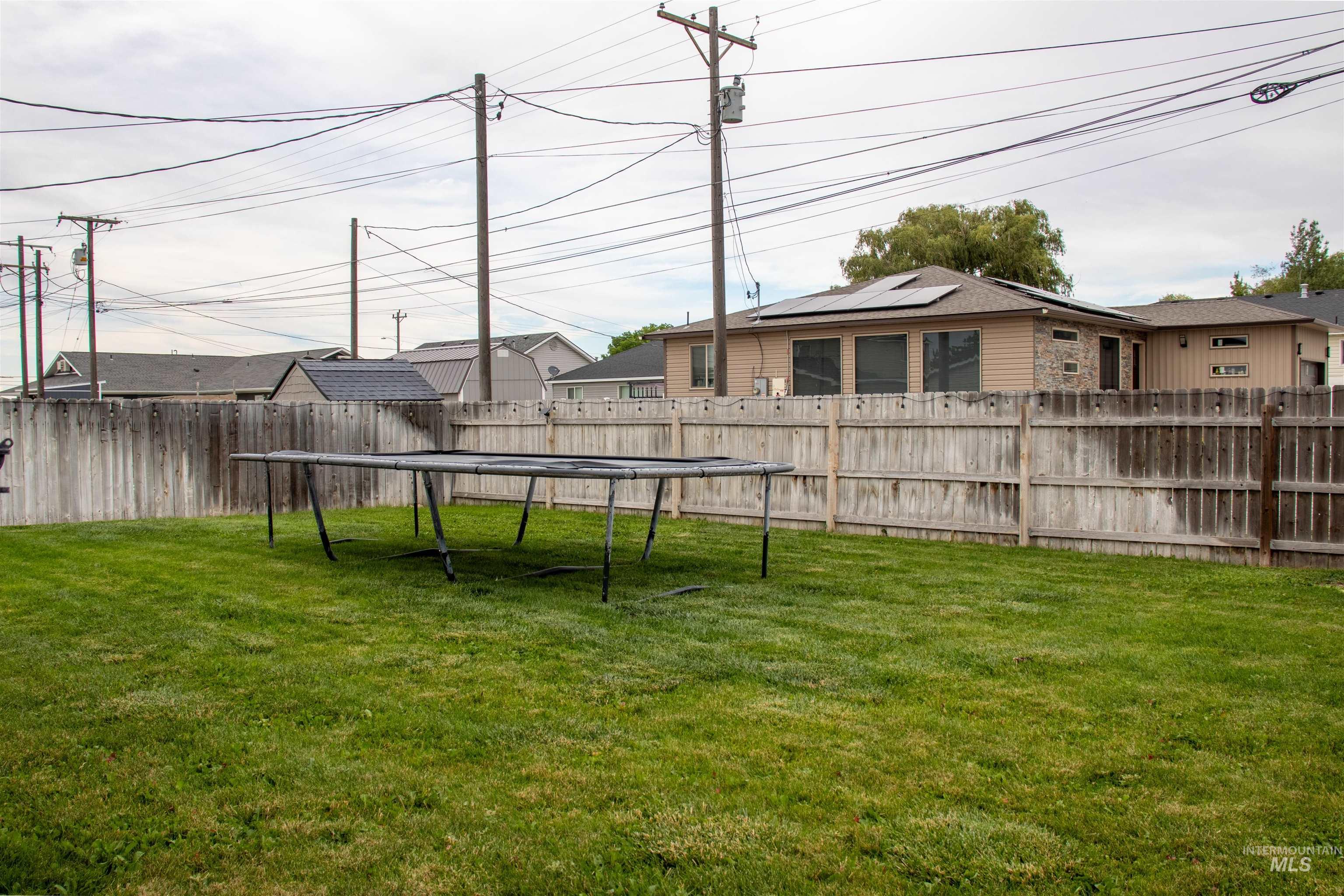 2000 M Street Heyburn, ID 83336 - Photo 13 of 15 Expansive fenced backyard featuring a manicured lawn and mature privacy fencing