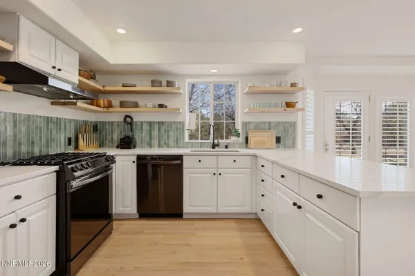 a kitchen with stainless steel appliances granite countertop a stove and a refrigerator