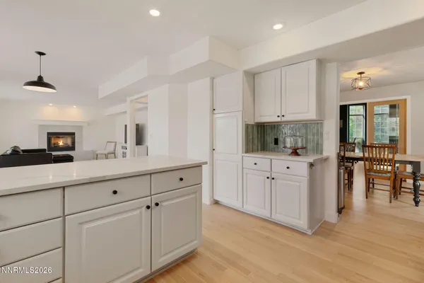 a kitchen with white cabinets and sink
