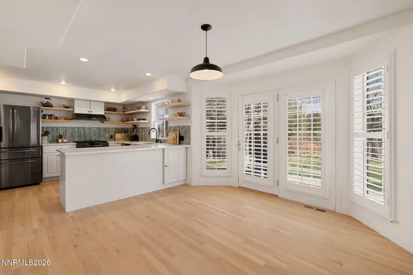 a kitchen with stainless steel appliances a stove top oven and a refrigerator