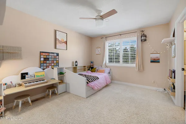 a bedroom with furniture and a window