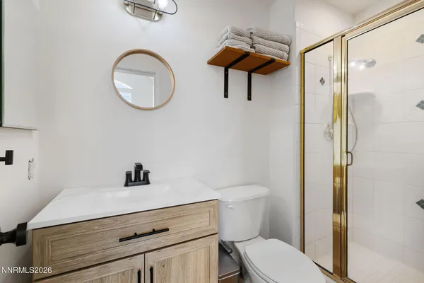 a bathroom with a toilet a sink and a mirror