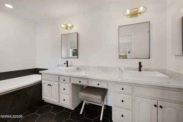 a spacious bathroom with a double vanity sink and a mirror