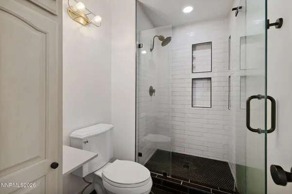 a bathroom with a toilet a sink and shower