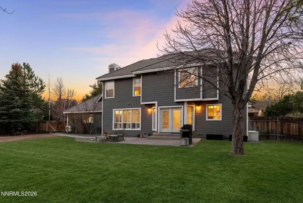 a front view of house with yard and green space