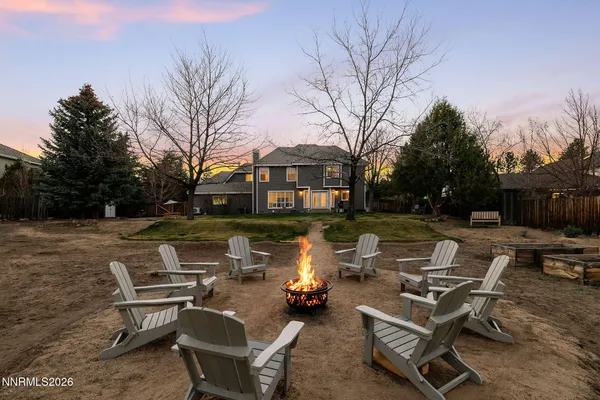 a front view of a house with garden and sitting area
