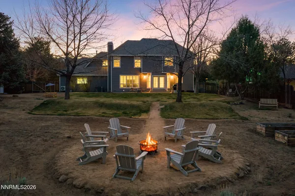 a backyard of a house with table and chairs