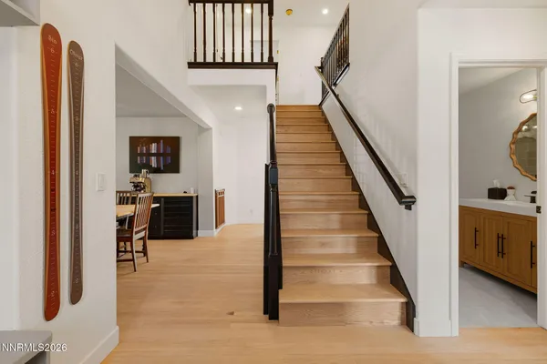a view of entryway and hall with wooden floor