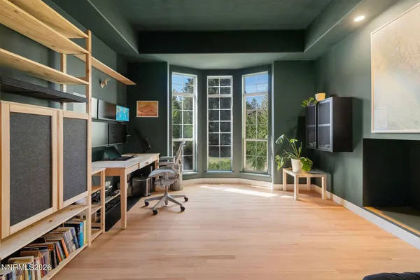 a work space with wooden floor and furniture