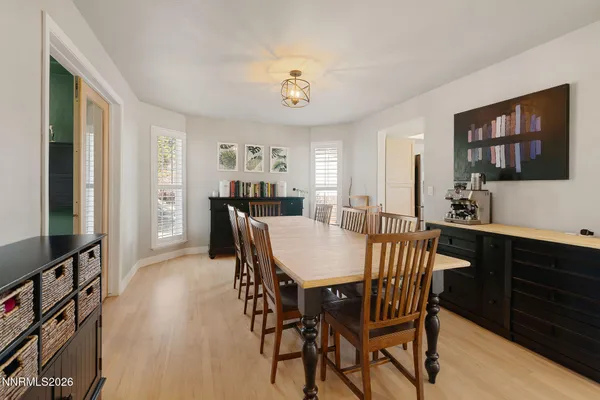 a view of a a dining room with furniture window and wooden floor