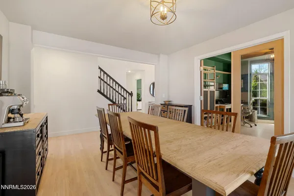 a view of a dining room with furniture and a chandelier