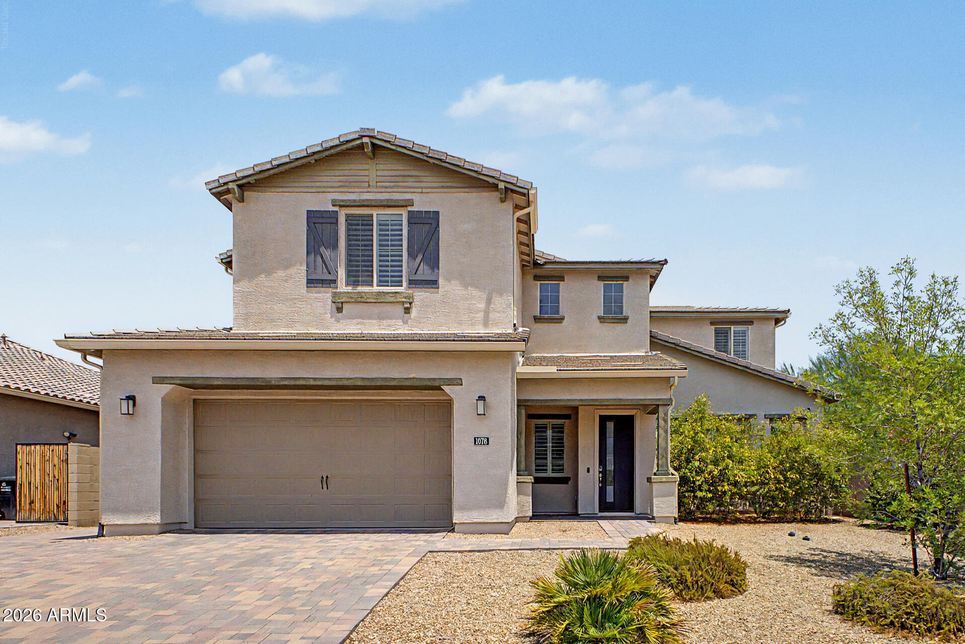 1076 East Kensington Road Gilbert, AZ 85297 - Photo 2 of 73 a front view of a house with a yard
