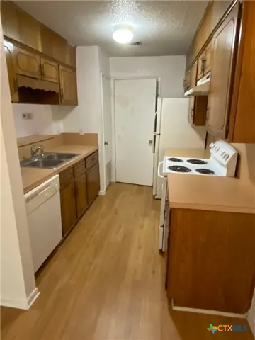 a view of a room with wooden floor