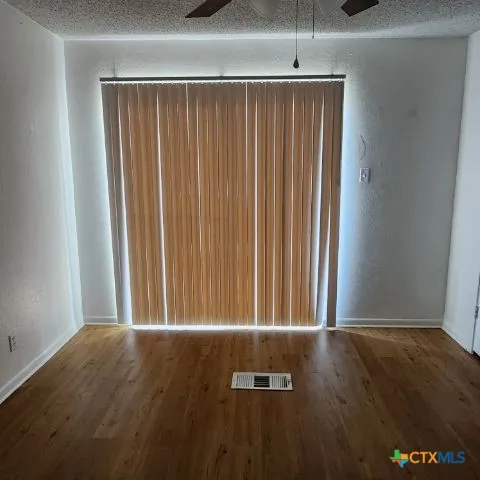 a bathroom with a granite countertop sink a toilet a mirror and bathtub