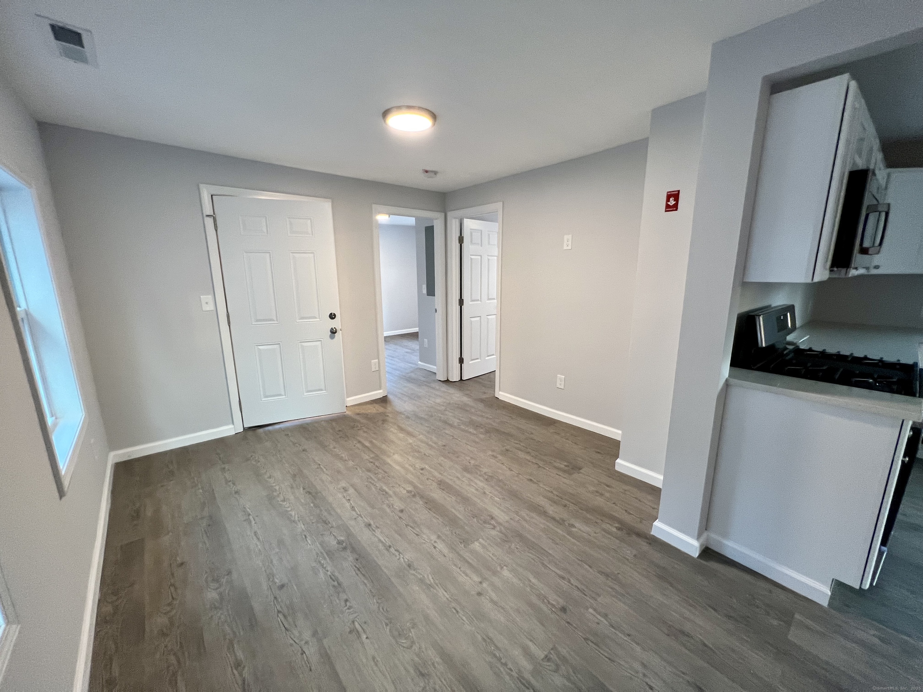 415 Hollister Avenue Bridgeport, CT 06607 - Photo 5 of 14 a view of a kitchen from a hallway