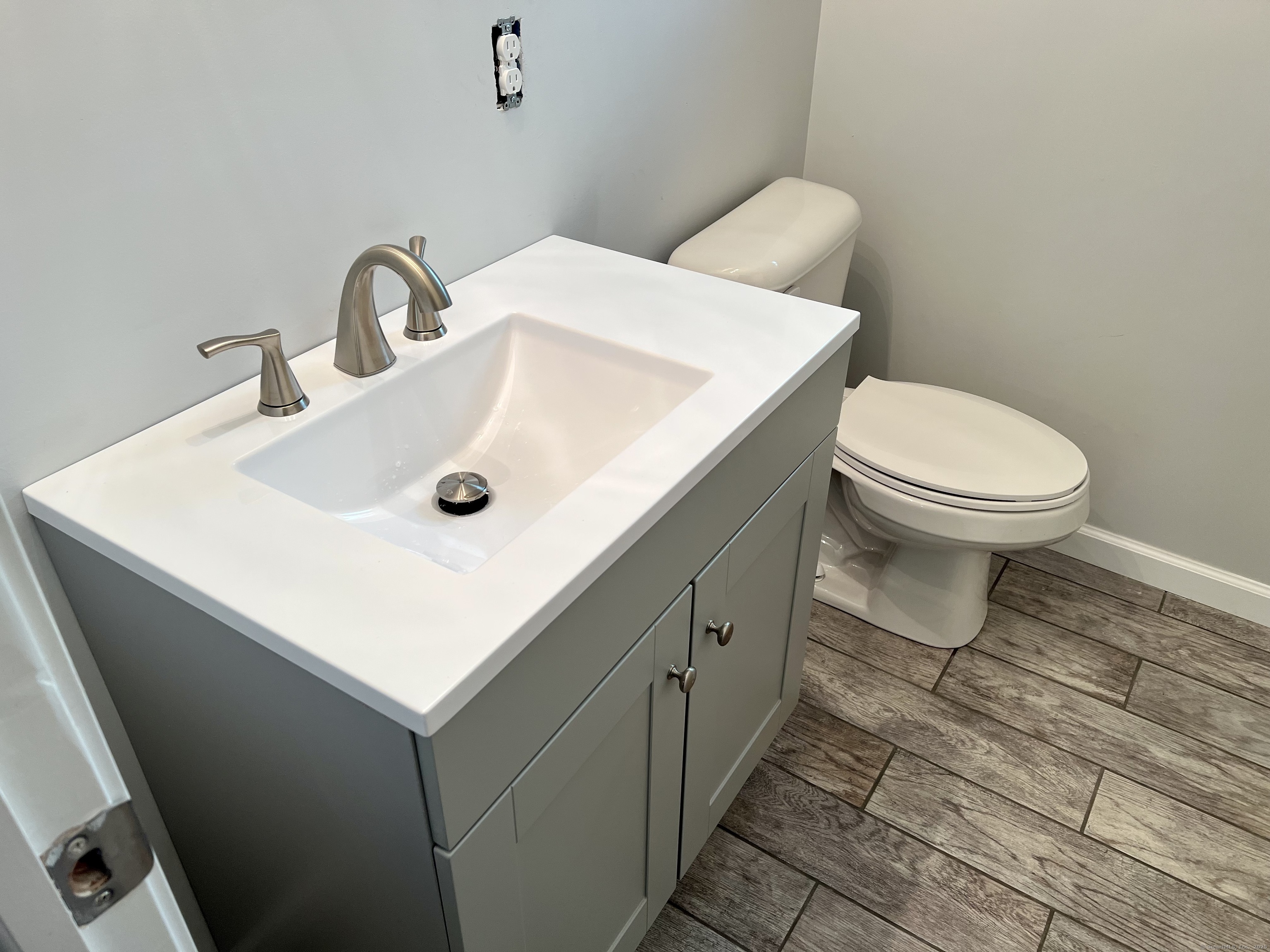 415 Hollister Avenue Bridgeport, CT 06607 - Photo 10 of 14 a bathroom with a sink mirror and toilet