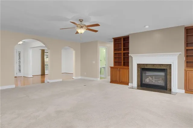 a view of a livingroom with a fireplace and a chandelier