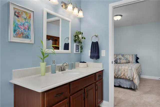 a en suite bathroom with a double vanity sink and a mirror