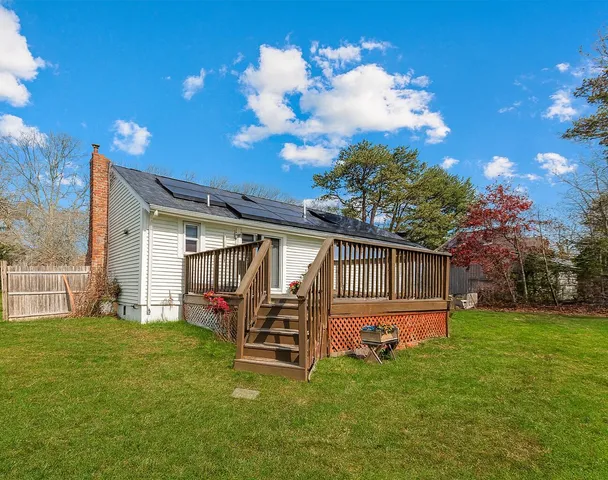 a backyard of a house with table and chairs
