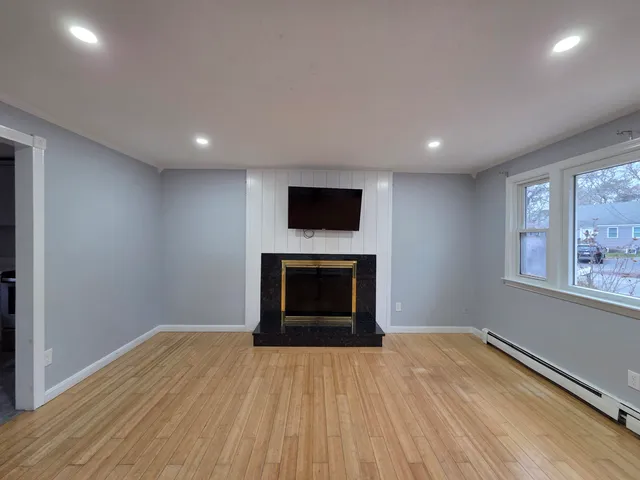 a view of empty room with a fireplace and fan