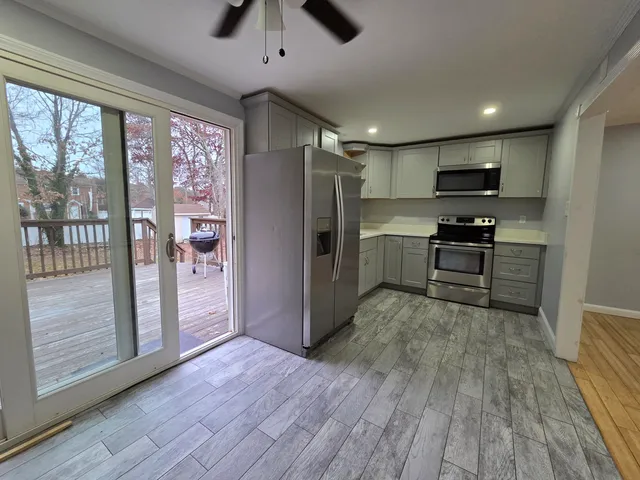 a kitchen with stainless steel appliances granite countertop a refrigerator and a stove