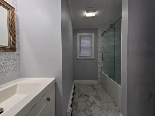 a bathroom with a bathtub and shower