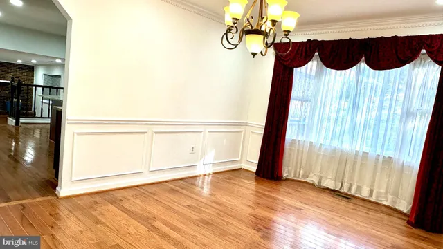 a view of a room with wooden floor and windows