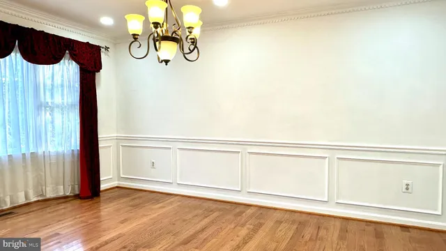 a kitchen with stainless steel appliances granite countertop white cabinets and a window