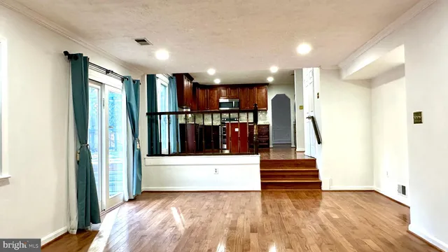 a view of a bedroom with wooden floor