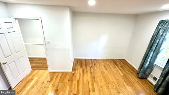 a bedroom with a bed and a ceiling fan